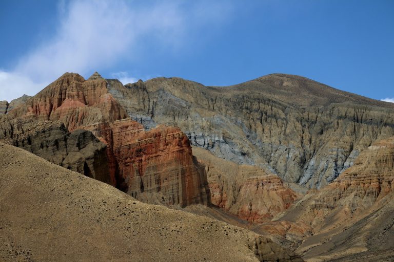 Colourful stratified mountains of Mustang under a blue sky