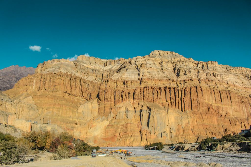 Eroded red cliffs of Upper Mustang under a blue sky